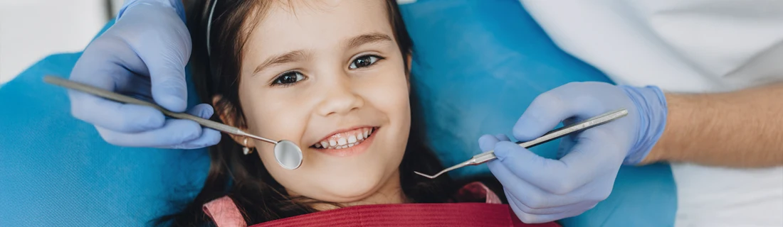 A young girls getting her teeth checked.