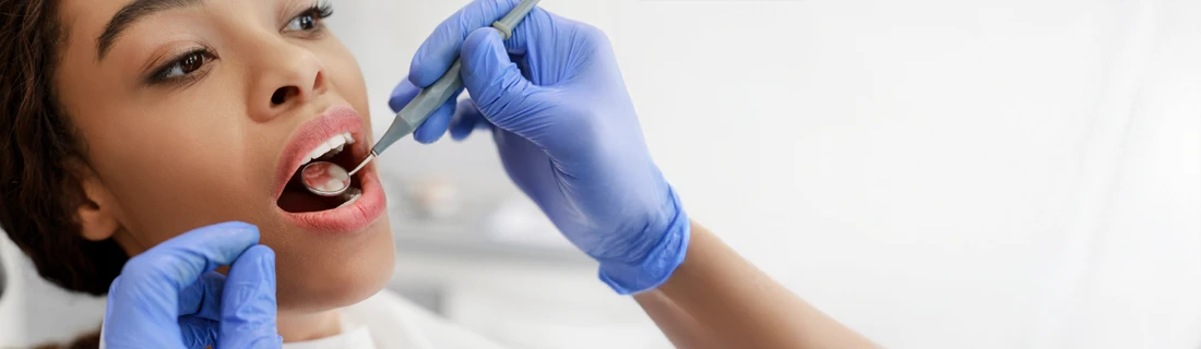A person receiving a tooth exam.